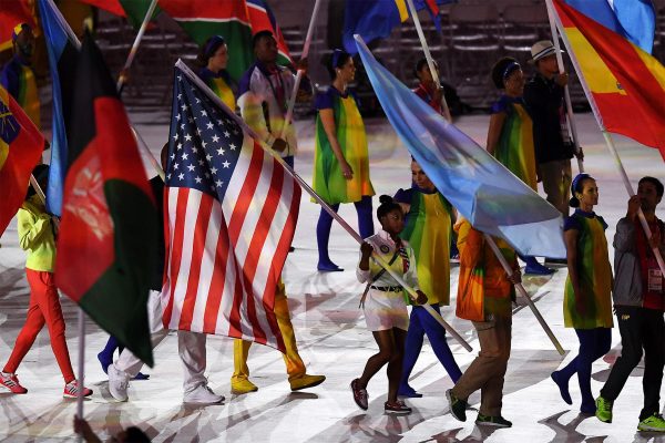 Simone Biles carrying the U.S. flag into the closing ceremony