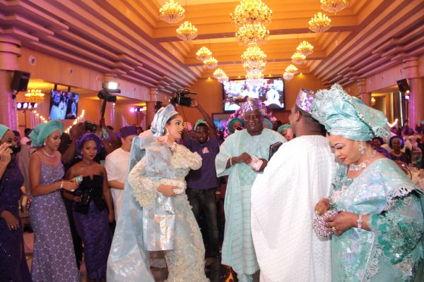 Bride and groom dance in presence of family
