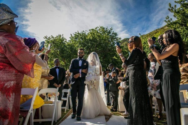 Adesua being walked down the aisle .