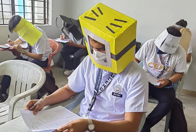EXTRA: Philippines students wear 'anti-cheating' hats during exam