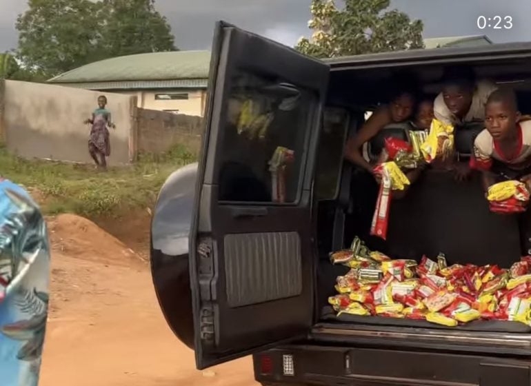 VIDEO: Portable distributes noodles to kids with his G-wagon