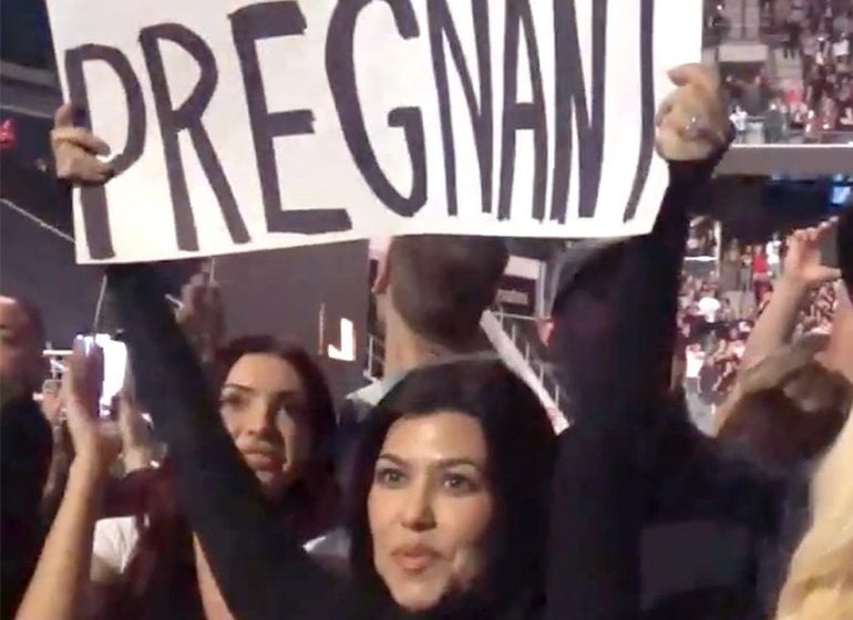 Kourtney Kardashian announces pregnancy with placard at husband's concert