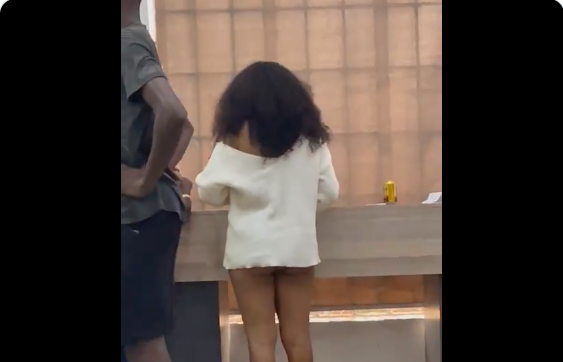 TRENDING VIDEO: Nigerian lady under fire over semi-nude dress to bank