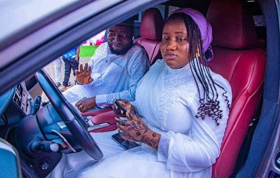 Yusuf Adamu Gagdi, a federal lawmaker representing Plateau state, and his daughter inside a SUV car