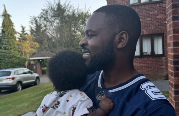 Rapper Falz holding a baby