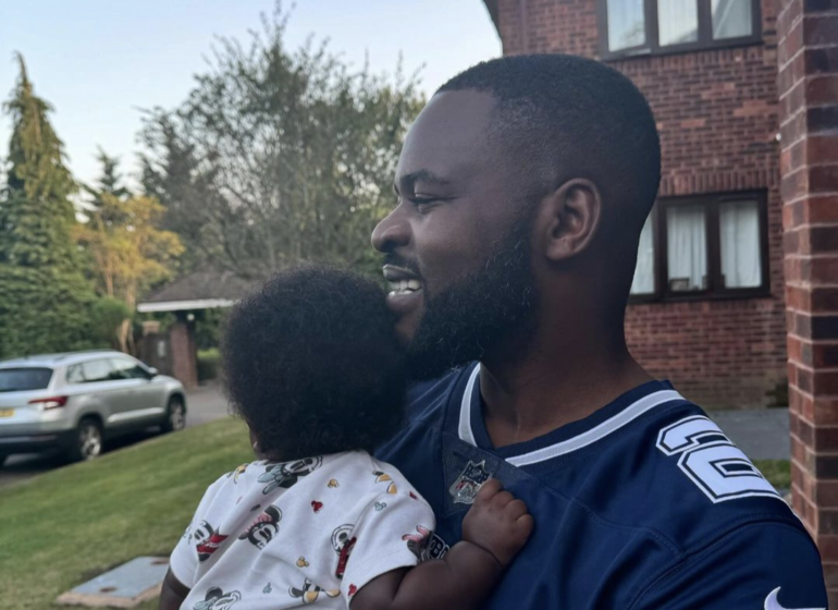 Rapper Falz holding a baby