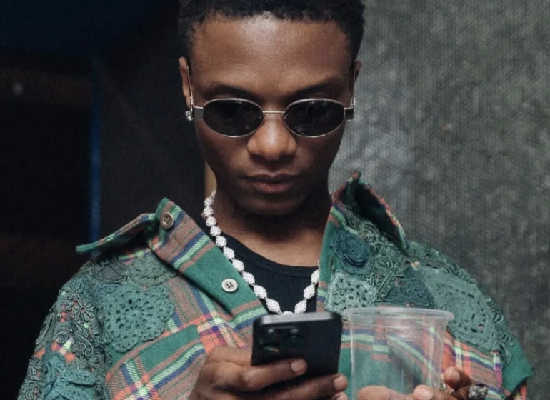 Wizkid holding a phone