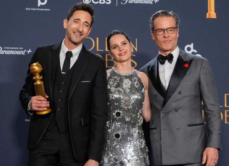 The Brutalist actor Adrien Brody with his co-stars Felicity Jones and Guy Pearce.